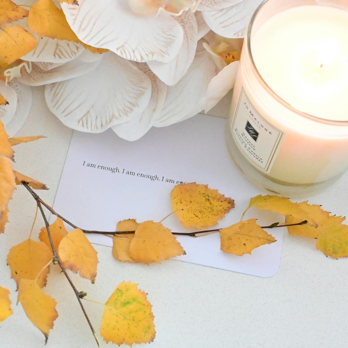 Scented candle in glass jar cozy flat lay