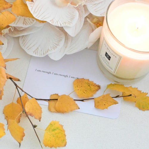 Scented candle in glass jar cozy flat lay