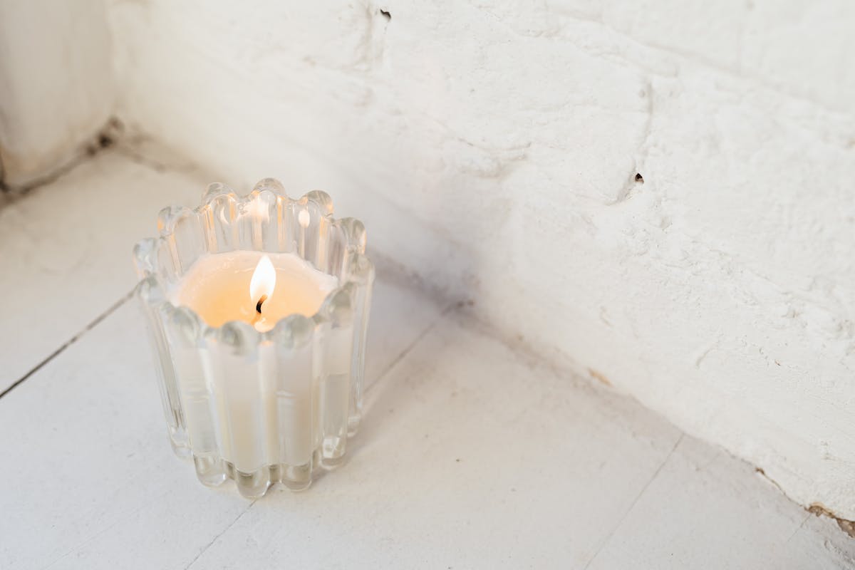 Burning candle in glass jar warm ambiance